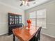 Cozy dining room showcasing a wooden table set, china cabinet, and natural light at 520 Ballyshannon Dr, Dacula, GA 30019