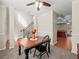 Bright dining room with a wooden table, ceiling fan, open to the kitchen, and living area at 520 Ballyshannon Dr, Dacula, GA 30019