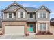 Beautiful two-story home with brick and siding, a two-car garage, and a bright teal front door at 520 Ballyshannon Dr, Dacula, GA 30019