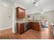 Open-concept kitchen with wood cabinetry, stainless steel appliances, and adjacent breakfast area at 520 Ballyshannon Dr, Dacula, GA 30019