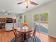Bright living room with wood floors, ceiling fan, patio door, and breakfast table at 520 Ballyshannon Dr, Dacula, GA 30019