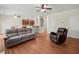 Open-concept living room with wood floors, ceiling fans, and a view into the kitchen and dining area at 520 Ballyshannon Dr, Dacula, GA 30019