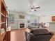 Living room showcasing wood floors, fireplace, built-in shelving, and access to breakfast nook and patio at 520 Ballyshannon Dr, Dacula, GA 30019