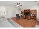 Spacious living room featuring wood floors, ceiling fan, and built-in shelving with entertainment center at 520 Ballyshannon Dr, Dacula, GA 30019