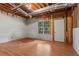 Unfinished basement with hardwood flooring, exposed ceiling, and natural light from window at 74 Rotunda Ct, Dallas, GA 30157
