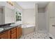 Well-appointed bathroom with dual sinks, soaking tub, stand up shower and stylish tile flooring at 74 Rotunda Ct, Dallas, GA 30157