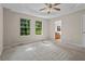 Large main bedroom with tray ceilings, carpet floors, and windows that offer natural light and scenic views at 74 Rotunda Ct, Dallas, GA 30157