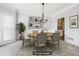 Bright dining room with gray walls, crown molding, and a stylish chandelier fixture at 2420 Millwater Xing, Dacula, GA 30019