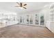 Well-lit living area with large windows, hardwood floors in kitchen and access to the deck at 2420 Millwater Xing, Dacula, GA 30019