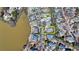 A peaceful aerial view shows the house nestled in a lakeside neighborhood with a yellow outline of the property lines at 2892 Darlington Run, Duluth, GA 30097