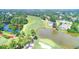 A scenic aerial view of a golf course community, including a pond and surrounding green landscape at 2892 Darlington Run, Duluth, GA 30097