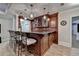 A sophisticated bar area featuring custom wood cabinetry, granite countertops, and pendant lighting at 2892 Darlington Run, Duluth, GA 30097