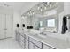 Bright bathroom with dual sinks, sleek cabinets, and a large mirror reflecting the shower and tub at 2892 Darlington Run, Duluth, GA 30097
