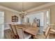 Large dining room with hardwood floors, chandelier, and open layout to the foyer at 2892 Darlington Run, Duluth, GA 30097