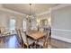 Spacious dining room with a large table, chandelier, and natural light, ideal for entertaining guests at 2892 Darlington Run, Duluth, GA 30097