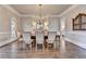 Formal dining room featuring a large table, chandelier, and stylish decor, perfect for hosting gatherings at 2892 Darlington Run, Duluth, GA 30097