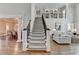 Grand foyer with a staircase, hardwood floors, and views into the dining room and living room at 2892 Darlington Run, Duluth, GA 30097
