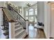 Grand foyer features a staircase with iron railings, hardwood floors, and a view of the living room at 2892 Darlington Run, Duluth, GA 30097