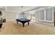 Spacious game room with a pool table, large windows, and a stone fireplace for entertaining guests at 2892 Darlington Run, Duluth, GA 30097