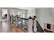The hallway features hardwood floors and an ornate wrought iron railing overlooking the open foyer and window at 2892 Darlington Run, Duluth, GA 30097