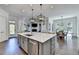 Spacious open-concept kitchen with a large island, stainless steel appliances, and hardwood floors at 2892 Darlington Run, Duluth, GA 30097