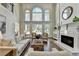 Bright living room showcasing large windows, a cozy fireplace, and stylish furniture at 2892 Darlington Run, Duluth, GA 30097