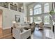 Spacious living room with tall windows, hardwood floors, and comfortable seating at 2892 Darlington Run, Duluth, GA 30097
