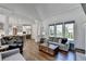 Open-concept living room with a view into the kitchen and large windows overlooking the yard at 2892 Darlington Run, Duluth, GA 30097
