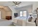 Comfortable main bedroom with a plush bed, large windows, and a ceiling fan for relaxation at 2892 Darlington Run, Duluth, GA 30097