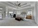 Large main bedroom with trey ceilings, neutral decor, and sitting area overlooking the backyard at 2892 Darlington Run, Duluth, GA 30097