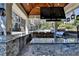 Outdoor kitchen has a stone counter and modern stainless steel grill at 2892 Darlington Run, Duluth, GA 30097