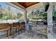 Outdoor kitchen with stone counter, stainless steel grill, and pendant lighting at 2892 Darlington Run, Duluth, GA 30097