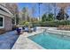 Outdoor swimming pool area with stone tile, a jacuzzi, and a conversation area with chairs at 2892 Darlington Run, Duluth, GA 30097