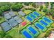 Overhead view of a tennis court complex with well-kept courts, surrounded by greenery and community buildings at 2892 Darlington Run, Duluth, GA 30097