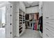 Elegant walk-in closet with extensive storage solutions, including shelving for shoes and hanging rods for clothing at 2892 Darlington Run, Duluth, GA 30097