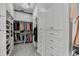 Luxurious walk-in closet with custom built-ins offers plenty of room for organization, with a crystal light fixture at 2892 Darlington Run, Duluth, GA 30097