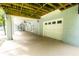 Covered back porch leading to a garage with overhead rafters and ceiling fans at 3045 Camp Branch Rd, Buford, GA 30519
