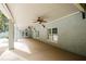 A spacious back porch with gray brick, concrete floors, and ceiling fans at 3045 Camp Branch Rd, Buford, GA 30519