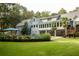 Large backyard with a swimming pool, patio, and landscaped garden at 3045 Camp Branch Rd, Buford, GA 30519