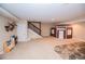 Spacious finished basement area featuring a playhouse, staircase, and neutral carpeting at 3045 Camp Branch Rd, Buford, GA 30519