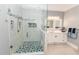 Modern bathroom with a glass shower, marble tiles, and a vanity with a backlit mirror providing ample lighting at 3045 Camp Branch Rd, Buford, GA 30519