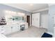 Spacious bathroom showcasing a double vanity with a backlit mirror, lots of storage, and gray walls at 3045 Camp Branch Rd, Buford, GA 30519