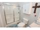 Bright bathroom featuring a shower with glass doors, built-in cabinet, and modern fixtures at 3045 Camp Branch Rd, Buford, GA 30519