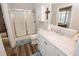 Bathroom featuring a glass shower, marble countertop, and white cabinets for a clean and modern design at 3045 Camp Branch Rd, Buford, GA 30519