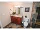 Bathroom featuring granite countertops, a toilet, framed quote art, decorative plant and stone tile shower at 3045 Camp Branch Rd, Buford, GA 30519