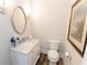 Stylish powder room features marble countertop, decorative mirror and flooring at 3045 Camp Branch Rd, Buford, GA 30519