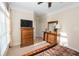 Bedroom featuring a plush bed, natural lighting, wood furnishings, and neutral color scheme at 3045 Camp Branch Rd, Buford, GA 30519