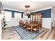Elegant dining room featuring a wooden table, china cabinet, and wainscoting at 3045 Camp Branch Rd, Buford, GA 30519