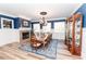Elegant dining room with a fireplace, featuring a beautiful chandelier and stylish decor at 3045 Camp Branch Rd, Buford, GA 30519