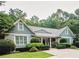 Charming home with classic architecture, lush landscaping, and welcoming entrance at 3045 Camp Branch Rd, Buford, GA 30519